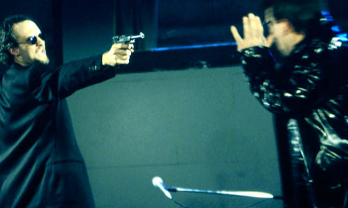 Presley (Jeff Talbot) pulls his vintage Luger on Crotch (Kevin Henderson).