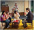 Ritchie (John Goode) takes his first sip of drugged tea while the girls (Elizabeth Wong, Kerry Sullivan, Trista Dellyn, and Meredith Lucio) look on.
