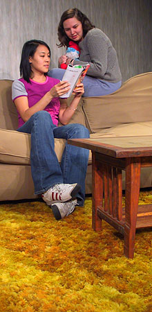 Tonigirl (Elizabeth Wong) and Vincenza (Meredith Lucio) share a fond moment over a teen magazine.