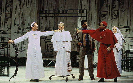 Pope (Paul Niebanck) rests his pathologically outstretched 
						arms on his bow and his dummy while Cardinal Pialli 
						(James Shanklin) strategizes for a cure while Professor 
						Ridolfi (Obi Ndefo) and Sister Gabriella (Meg Brogan) look on.