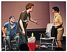 Frank (Joshua Alscher) attempts to calm Bandaged Woman (Pat Champon) after she walloped Max (Corey Patrick) with her handbag.