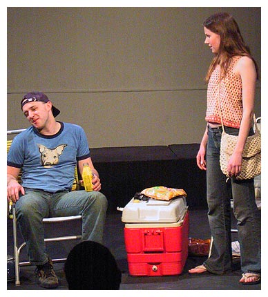 Chloe (Anne Jordan) tries to coax Max (Corey Patrick) out of his chair and off the roof to attend a concert.